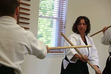 Men and Women black belt students from Burlington & Gloucester County practice fundamental weapons training that teach the principles of redirection of force to control the line of attack.