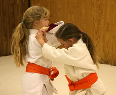 Girls at Agatsu Dojos in South Jersey practice self-defense with cooperation and focus. Technique takes the balance of the attacker with awareness and control.