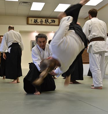 Adult class in action at the Headquarters Dojo of Agatsu Dojos. Students learn the Traditional Art of Aikido with the health benefits of fitness, personal development and effective self-defense.